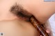 A close up of a woman's face with a hairy penis.