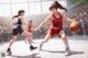 A group of young women playing a game of basketball.