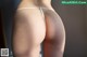 A close up of a woman's butt in a white thong.